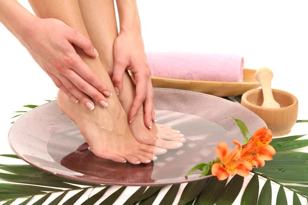 Female feet in spa bowl with water, isolated on white — Stock Photo, Image