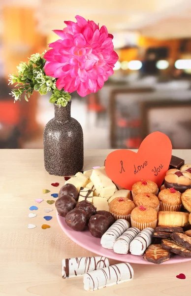 Sweet cookies with valentine card on plate on table in cafe Royalty Free Stock Photos
