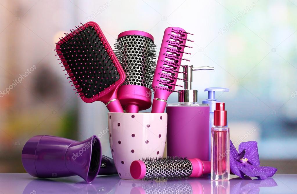 Hair brushes, hairdryer and cosmetic bottles in beauty salo