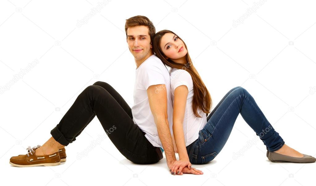 Loving couple sitting with back to each other on floor isolated on white