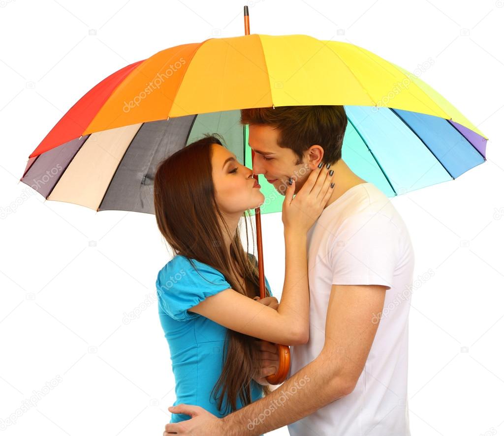 Loving couple standing with umbrella isolated on white