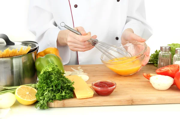 Female hands blending eggs in glass bowl — Stock Photo, Image