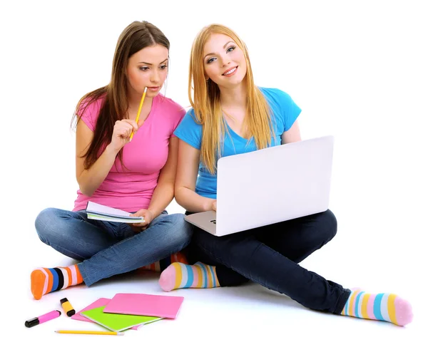 Two girl friends with with laptop isolated on white — Stock Photo, Image