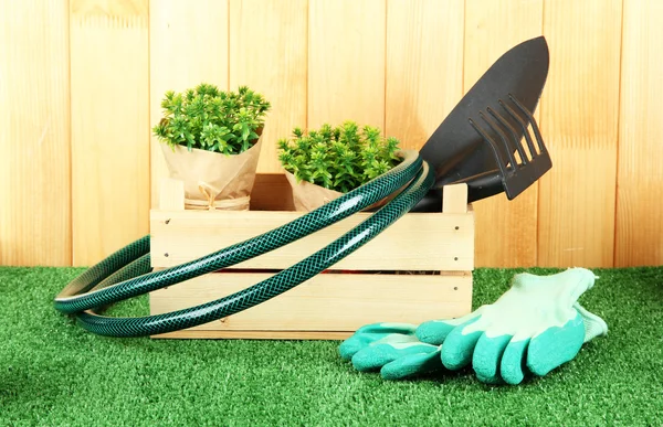 Garden tools on grass in yard — Stock Photo, Image