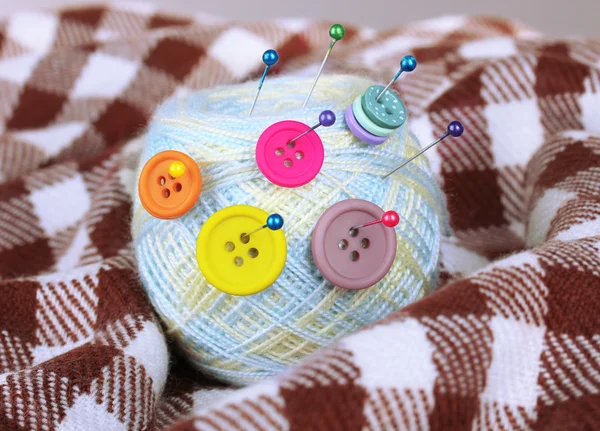 Ball of thread on checked plaid — Stock Photo, Image