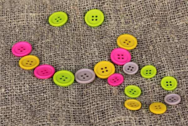 Bright color buttons on sacking — Zdjęcie stockowe