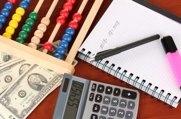 Bright wooden abacus and calculator.Conceptual photo of old and modern business — Stock Photo, Image