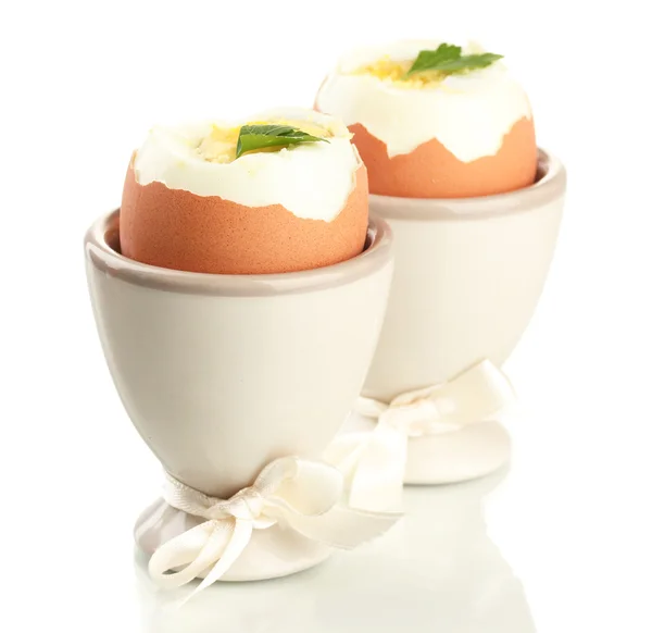 Boiled eggs in egg cups, isolated on white — Stock Photo, Image