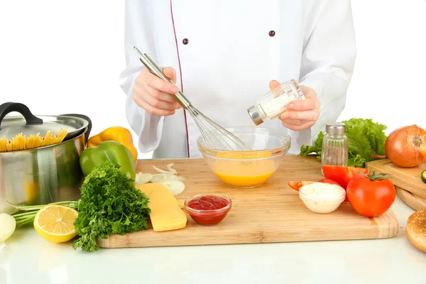 Female hands blending eggs in glass bowl — Stock Photo, Image