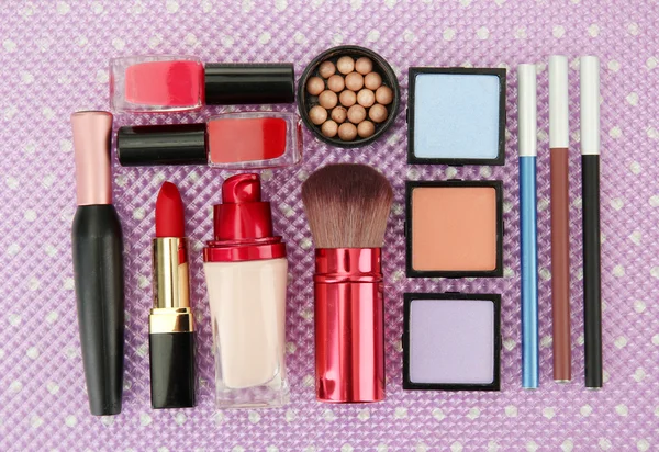 Decorative cosmetics on purple background — Stock Photo, Image