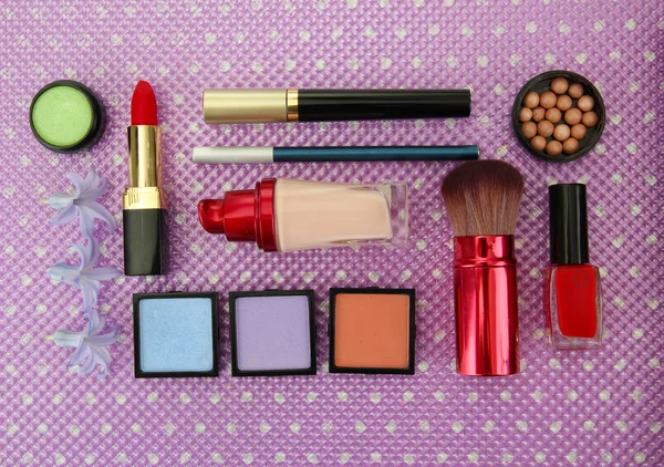 Decorative cosmetics on purple background — Stock Photo, Image