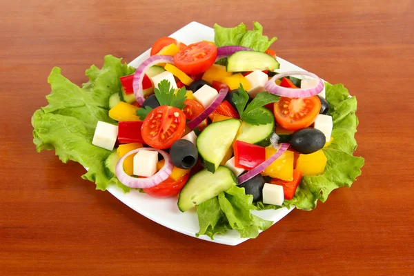 Tasty Greek salad on wooden background — Stock Photo, Image