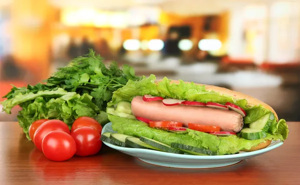Tasty hot dog on table in cafe — Stock Photo, Image