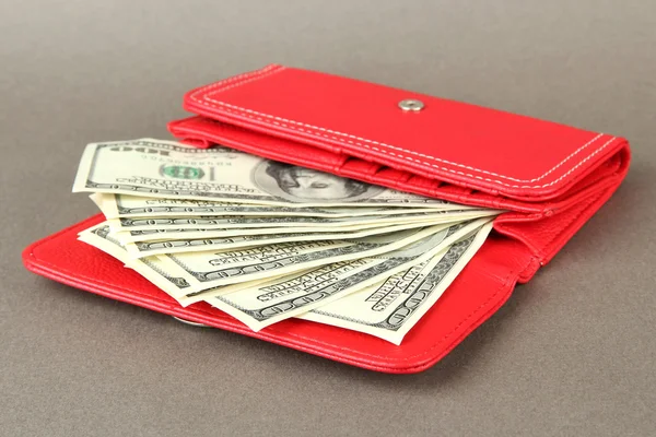 Purse with hundred dollar banknotes, on color background — Stock Photo, Image