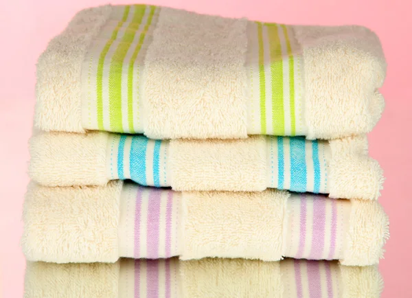Bath towels on pink background — Stock Photo, Image