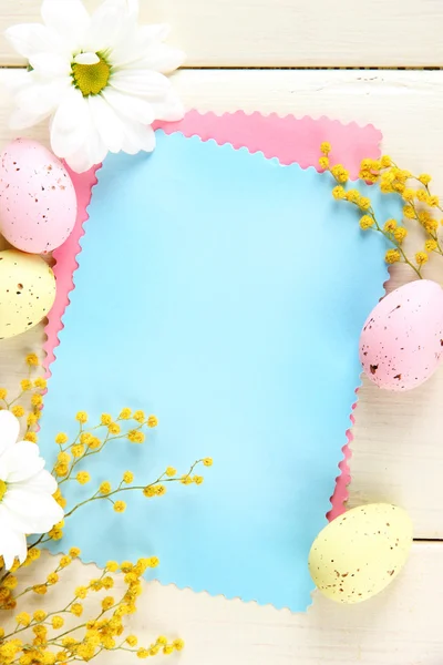 Empty card with easter eggs and mimosa flowers, on white wooden background — Stock Photo, Image