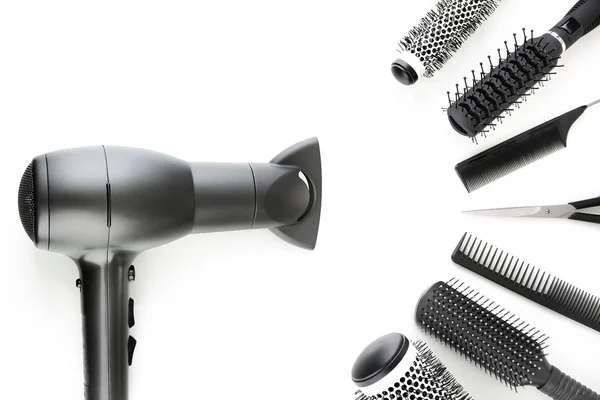 Comb brushes, hairdryer and cutting shears, isolated on white — Stock Photo, Image