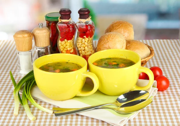 Fragrant soup in cups on table in kitchen — Stock Photo, Image