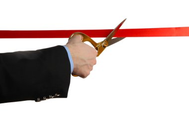 Man's hand cutting red ribbon with pair of scissors isolated on white clipart