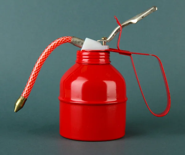 Red oil can, on color background — Stock Photo, Image