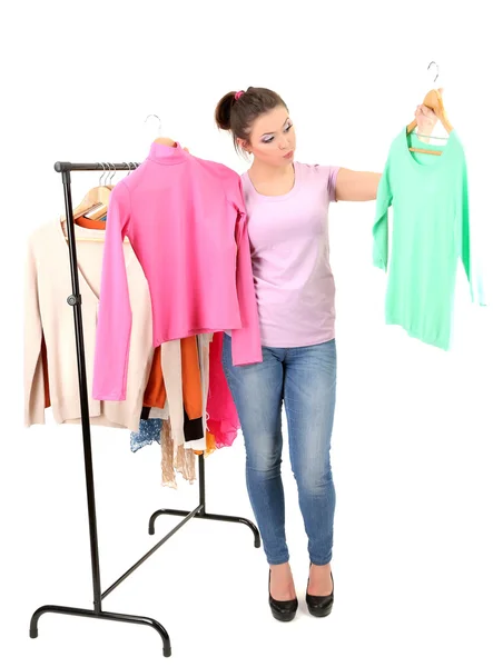 Chica joven comprando ropa aislada en blanco — Foto de Stock