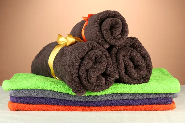 Colorful towels, on brown background — Zdjęcie stockowe