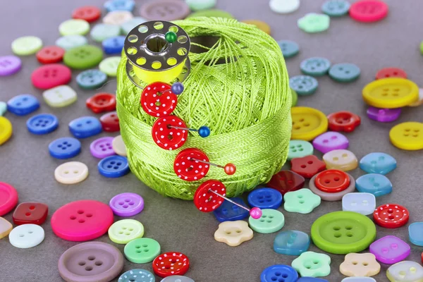 Buttons of different shapes, sizes and colors close-up on gray background — Stock Photo, Image