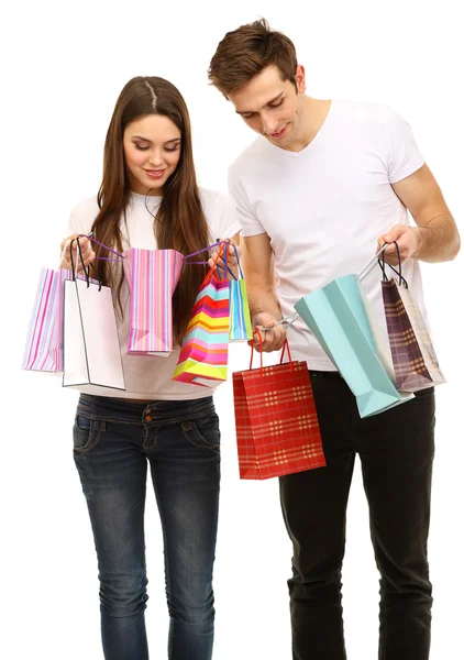 Young couple shopping and holding many shopping bags isolated on white Stock Photo