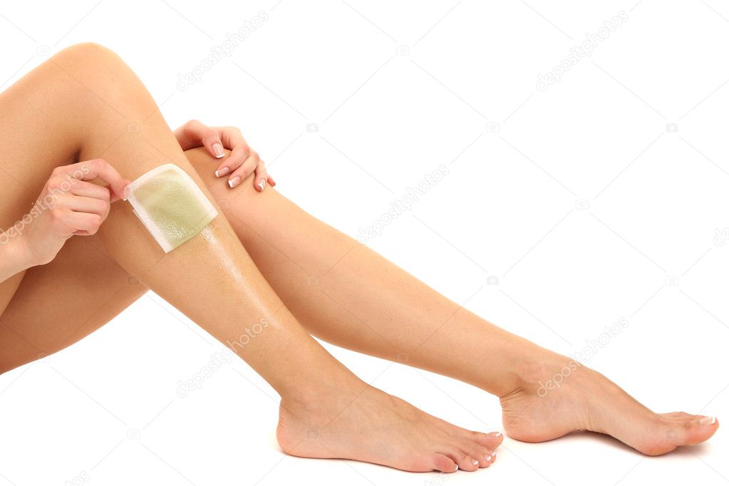 Beautiful woman doing depilation for her legs with waxing, isolated on white