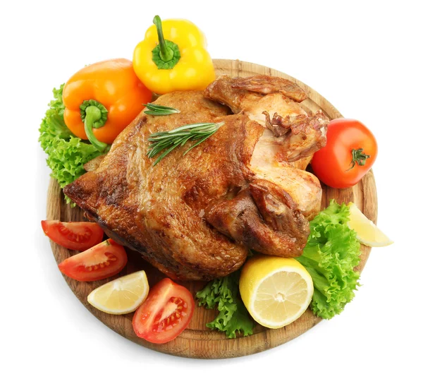 Whole roasted chicken on wooden plate with vegetables, isolated on white — Stock Photo, Image