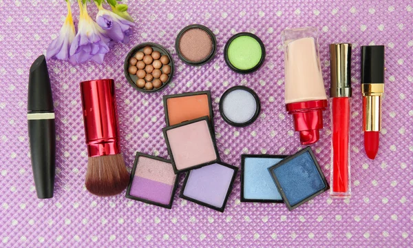 Decorative cosmetics on purple background — Stock Photo, Image