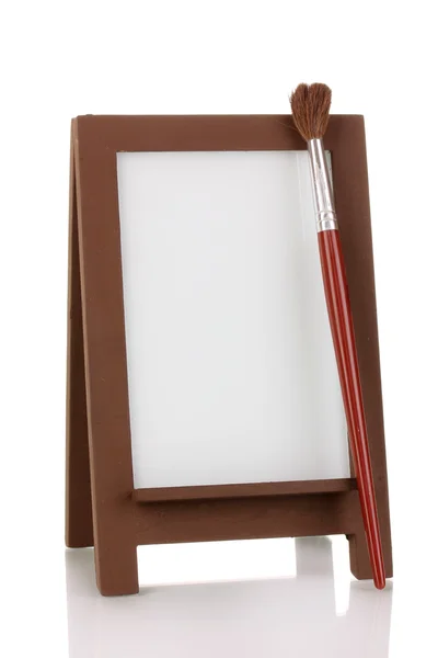 Photo frame as easel with artist's tools isolated on white — Stock Photo, Image