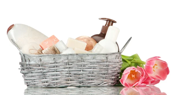 Composition of cosmetic bottles and soap in basket, isolated on white — Stock Photo, Image