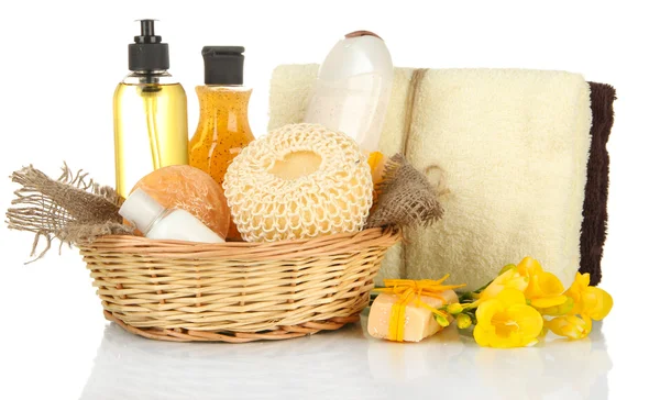 Composition of cosmetic bottles and soap in basket, isolated on white — Stock Photo, Image