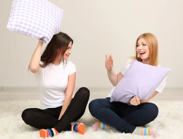 Deux filles amis bataille d'oreillers sur la chambre — Photo