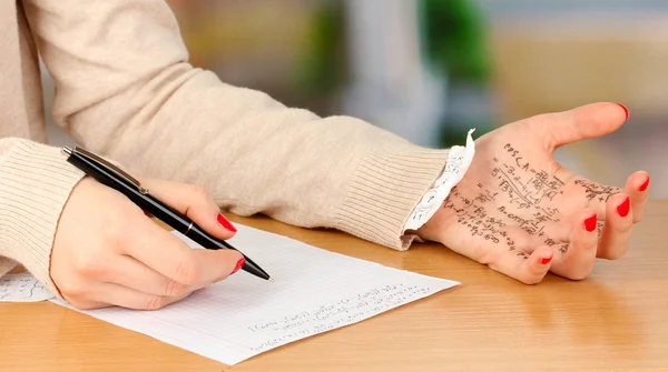 Write off exam on wooden table on room background — Stock Photo, Image