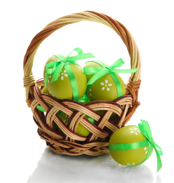 Bright easter eggs with bows in basket, isolated on white — Stock Photo, Image