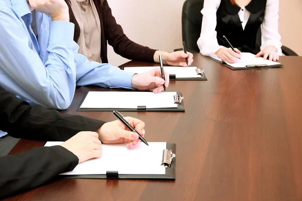 Row of hands making notes — Stock Photo, Image