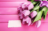 Картина, постер, плакат, фотообои "beautiful bouquet of purple tulips on pink wooden background", артикул 22375627