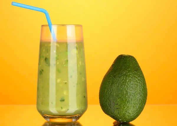 Abacate fresco útil sobre fundo laranja — Fotografia de Stock