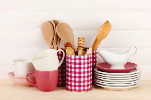 Cups, bowls nd other utensils in metal containers isolated on light background — Stock Photo, Image