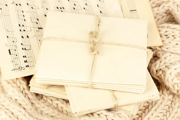 Stacks of old letters and music sheets on soft scarf — Stock Photo, Image