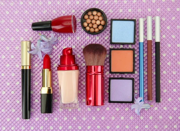 Decorative cosmetics on purple background — Stock Photo, Image