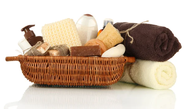 Composition of cosmetic bottles and soap in basket, isolated on white — Stock Photo, Image