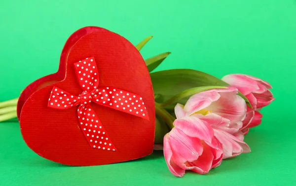 Pink tulips and gift box, on color background — Stock Photo, Image