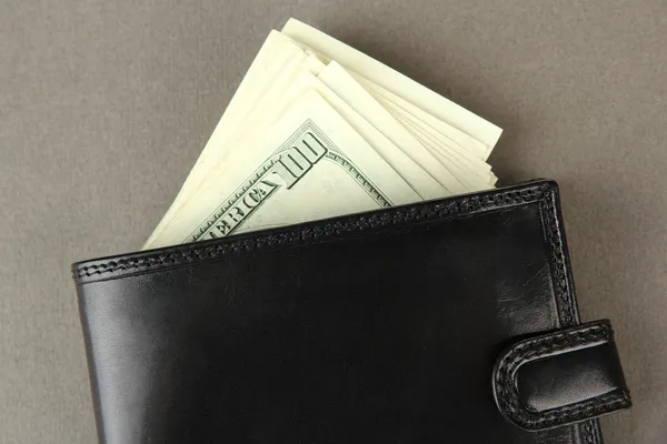 Wallet with hundred dollar banknotes, on color background — Stock Photo, Image