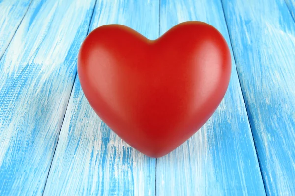 Decorative red heart on color wooden background — Stock Photo, Image