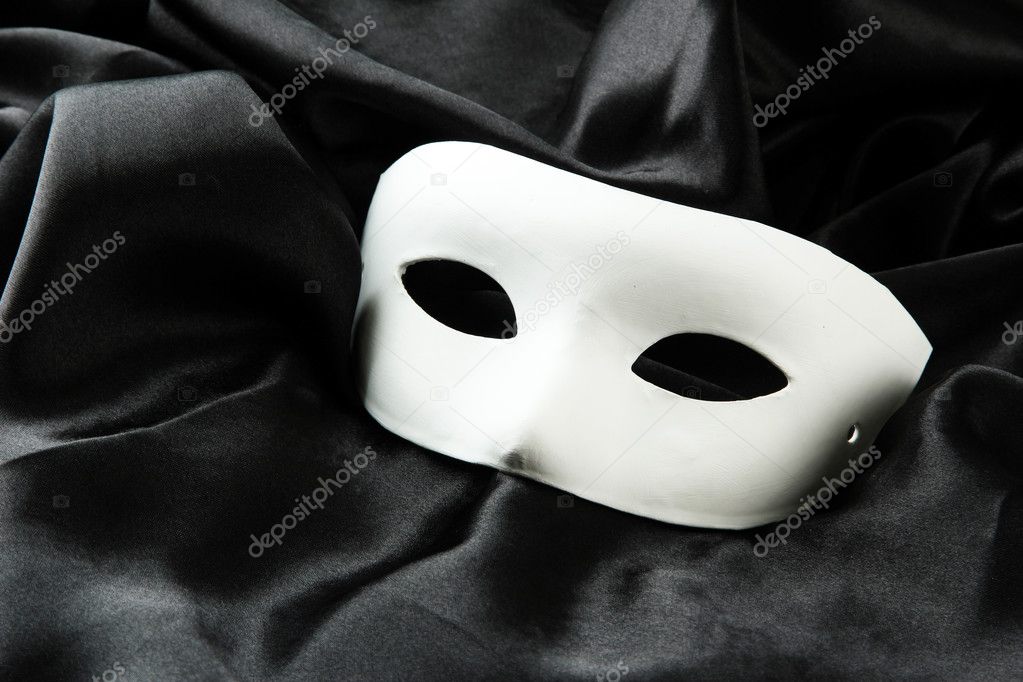 White mask, on black silk fabric