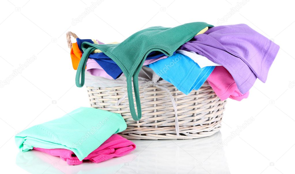 Clothes in wooden basket isolated on white