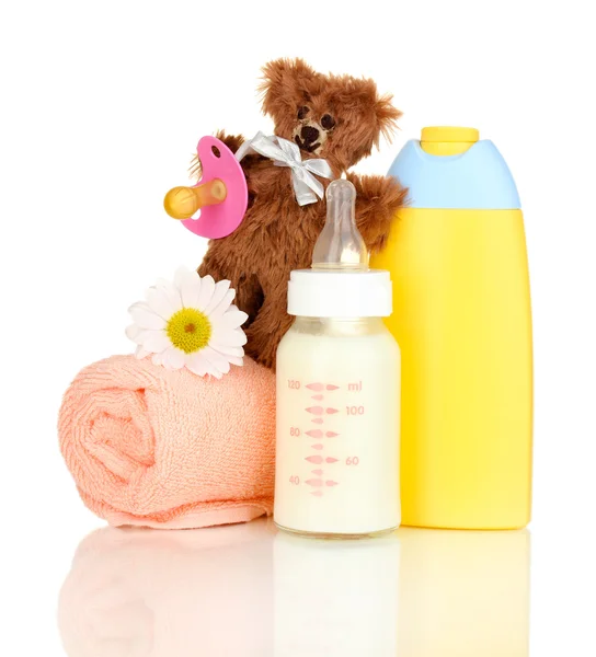 Bottle of milk, pacifier and baby cosmetic with towel isolated on white — Stock Photo, Image